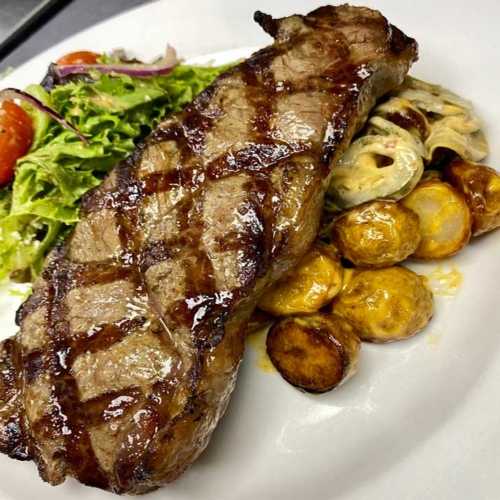 Juicy New York Strip Steak served at Palace South Beach