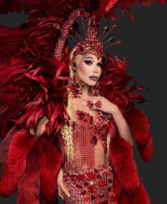 Drag performer in an elaborate red feather costume with jeweled headdress for Palace South Beach in Miami Beach