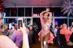 Drag queen performing between tables at Palace Drag Brunch in South Beach Miami